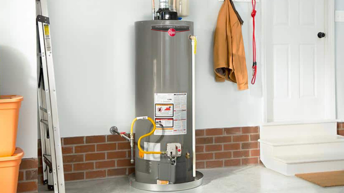 Tank water heater inside garage next to door
