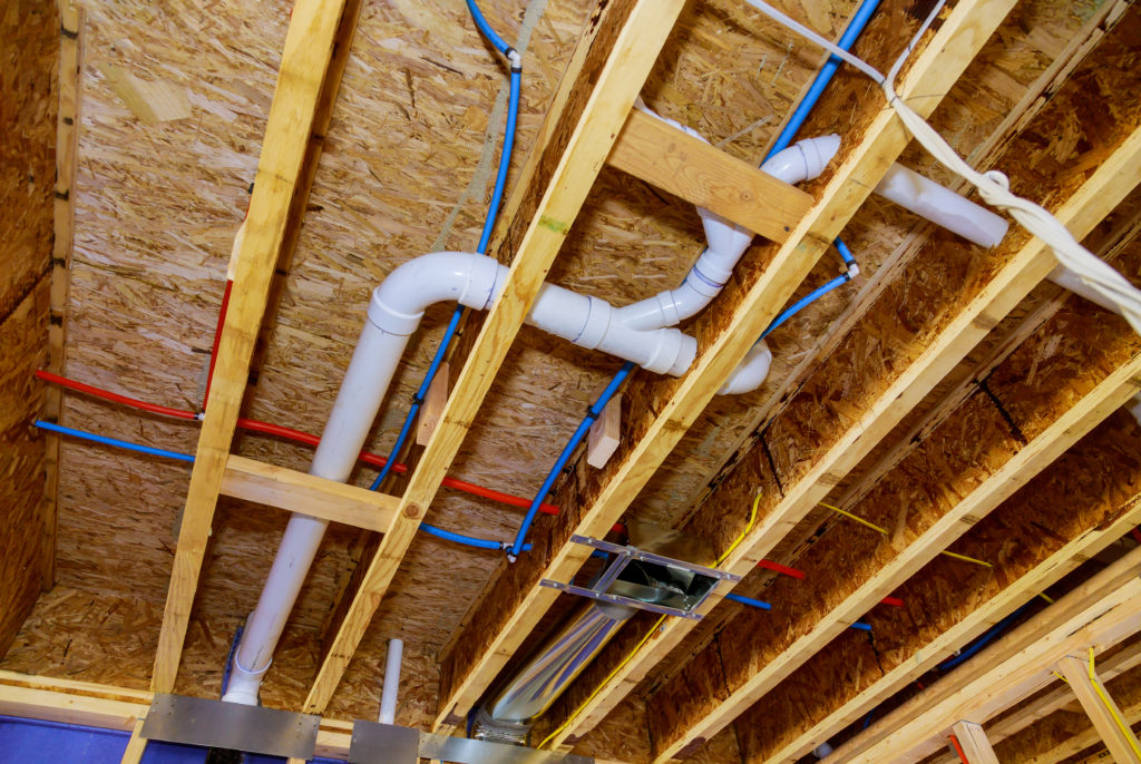 blue and red pex plumbing photo with white pipe near it under a wooden floor ceiling picture